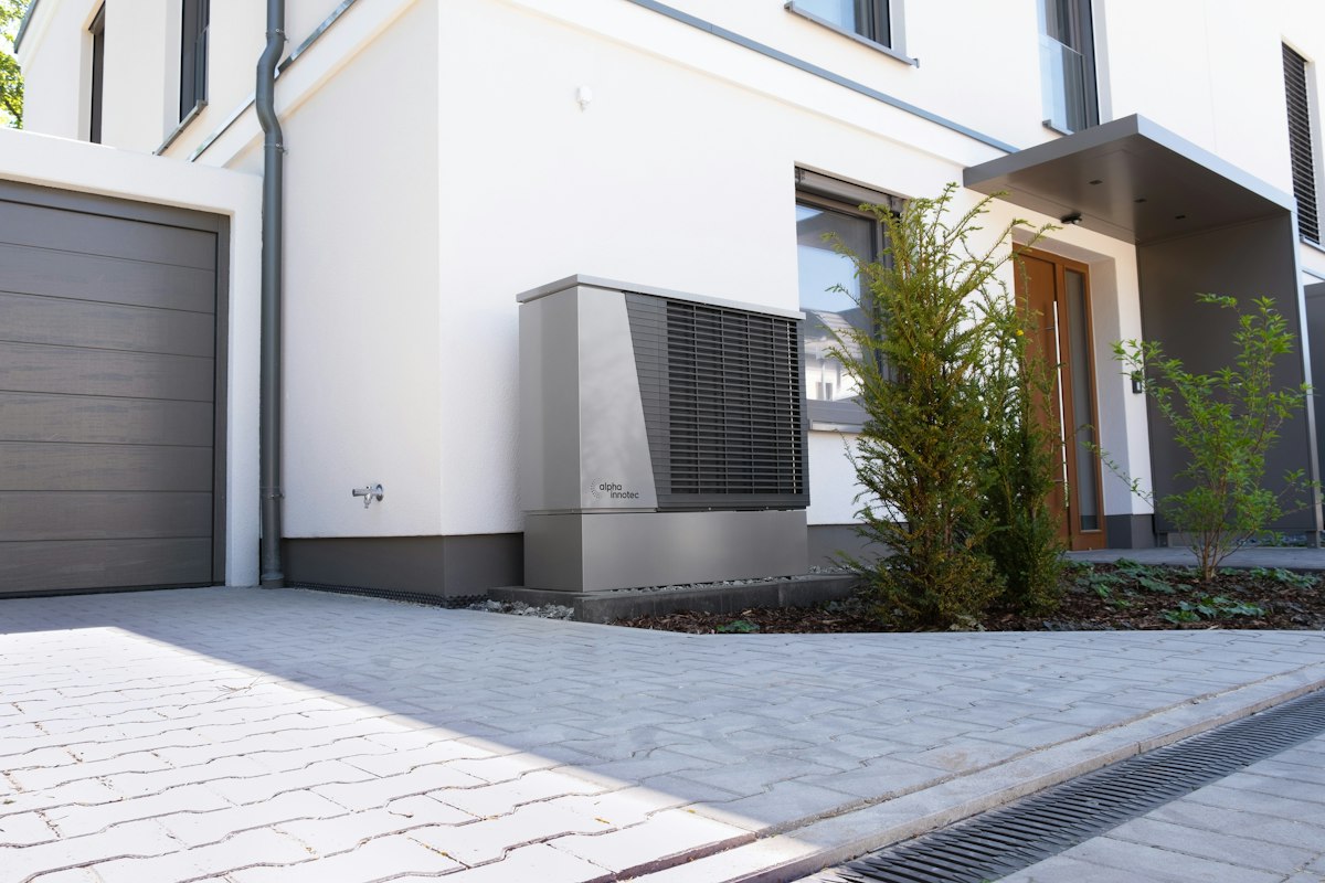 Heat pump installed beside a home